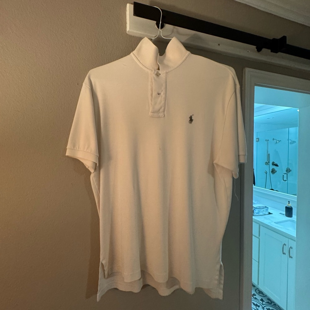 Medium cream color polo. Small stain which is not noticeable